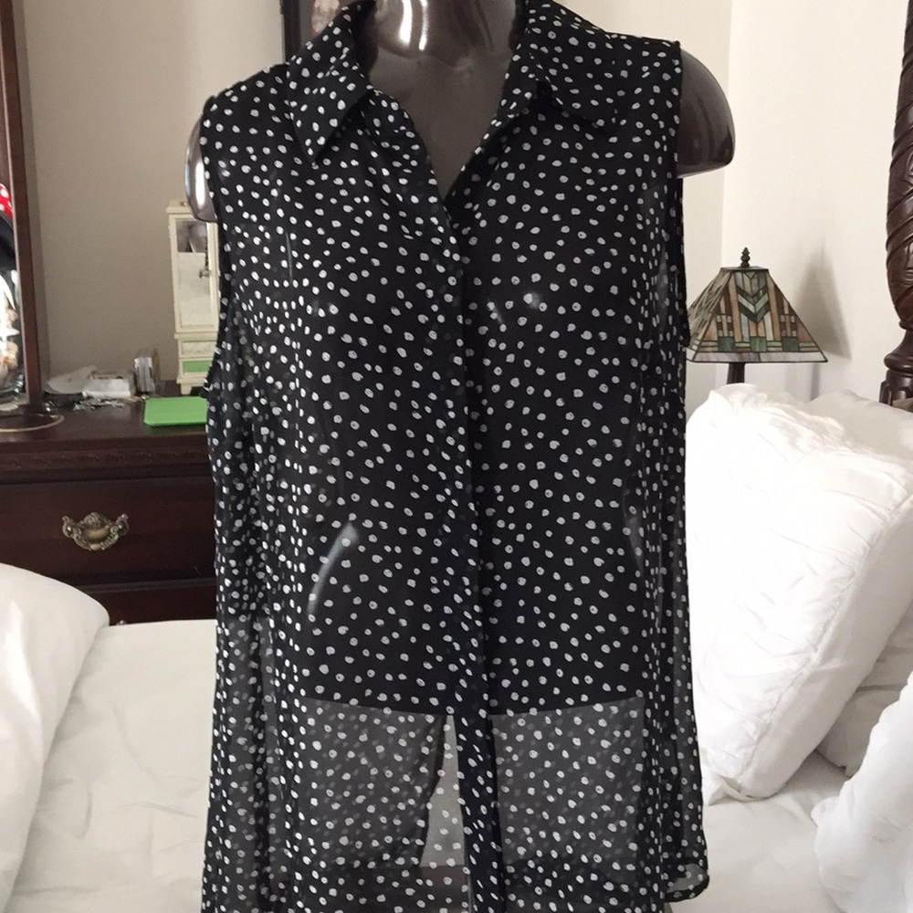 Sleeveless black blouse with white polka dots